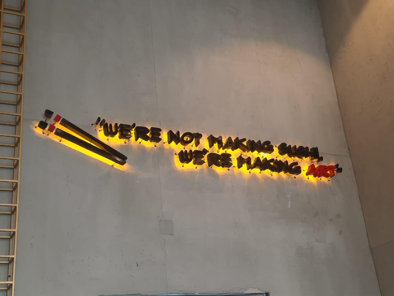 Masami Sushi, Riyadh: an illuminated script sign on the concrete-finish wall